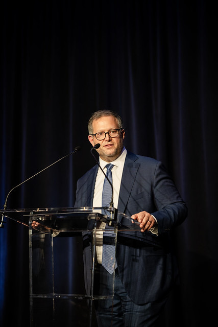 Oliver Libby delivering a keynote from the podium