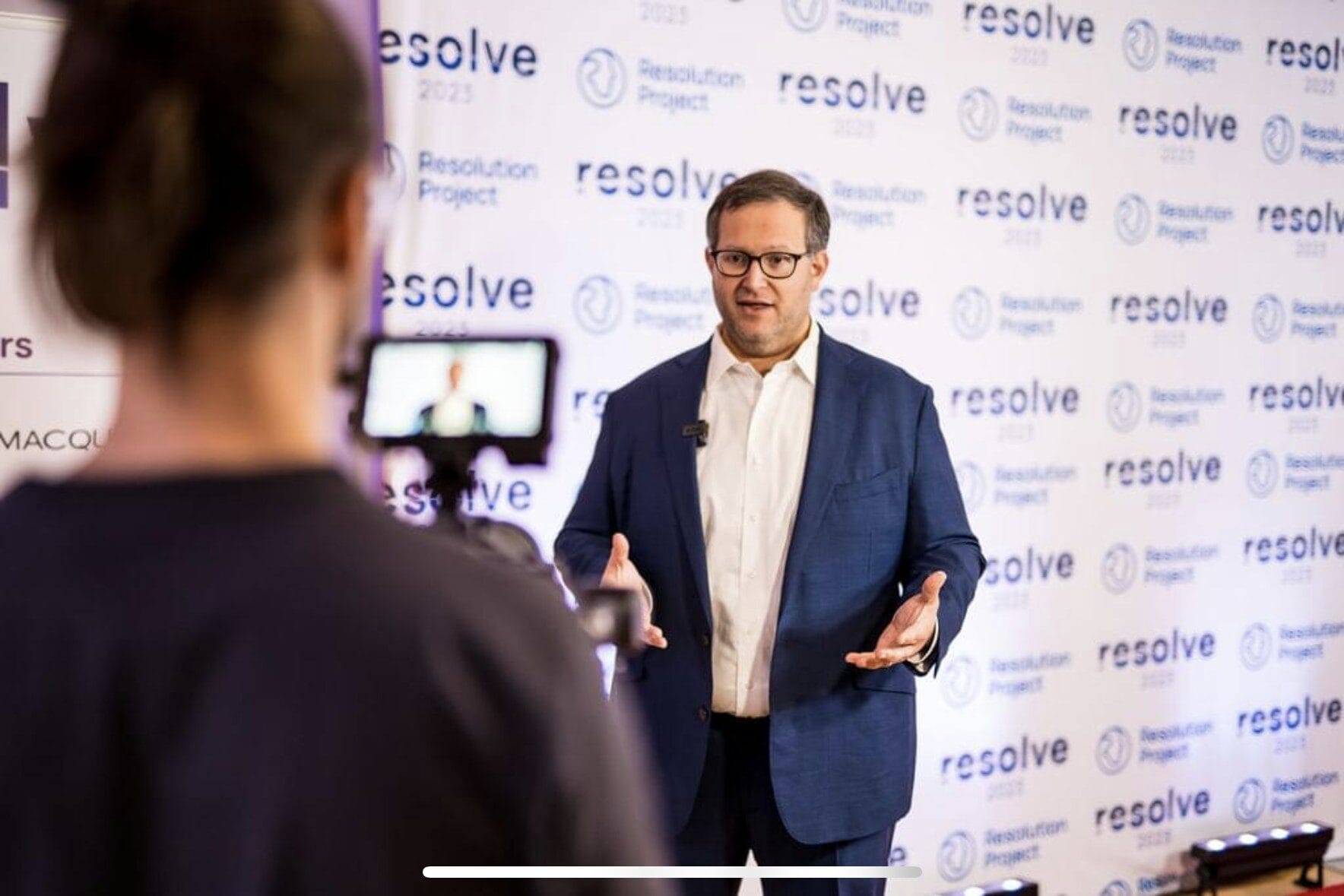 Oliver speaking at an event